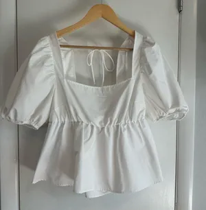 H&M Tie Detail Puff-Sleeved Peplum Blouse. White. Size: Large. thumbnail 1
