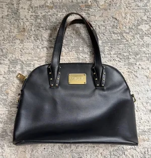 faux leather black Bebe shoulder bag with gold hardware and stud accents thumbnail 1