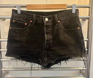 Levi’s 501 Button Fly Raw Hem Black Denim Shorts thumbnail 1