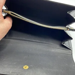Black faux patent leather clutch with wave design on front. thumbnail 6