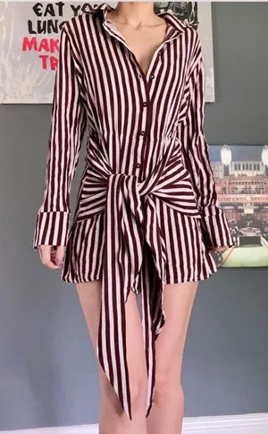Jen’s Pirate Booty Amaya brown and white striped mini dress in size XS. This has only been worn once and has no rips, tears, or stains. Some color transfer between stripes from washing but it’s not really noticeable as seen in photos. The waist can be tied in front with excess or in back (I like to go around twice and tie in back). Ultra soft and flowy material, love this dress and only selling as it just isn’t quite my style. Measures 30” long, 17” across chest, 14” across at waist, 22” long sleeve (from shoulder seam). thumbnail 1