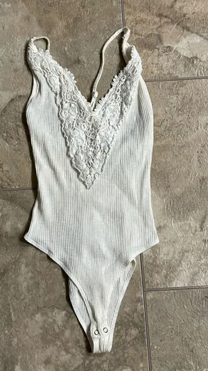 Forever 21 white ribbed bodysuit with a plunging V-neckline is a size small. thumbnail 1