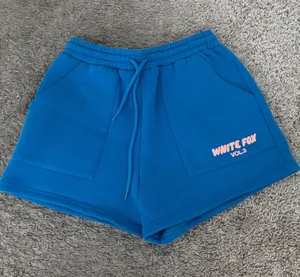 White Fox blue shorts with peach letters thumbnail 1