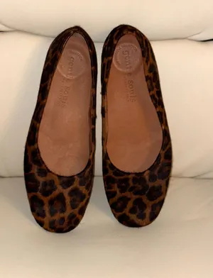 The shoes are Gentle Souls flats with a leopard print and a calfskin finish. thumbnail 1
