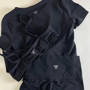 Aritzia Tna Butter Set this set comes with cheeky biker shorts, hold tight bra, and butter bound t-shirt all in black set retails for $136 thumbnail 1