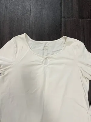 Soft cream long sleeve top with a modest scoop neckline. Features a small decorative ring keyhole at center front. Lightweight, easy to layer for casual or office wear. Simple, clean silhouette for versatile styling. J, Jill size medium. 95% cotton 5% spandex thumbnail 2