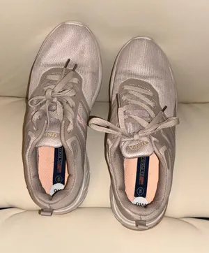 The sneakers are from the U.S. Polo Assn. brand in a pale pink tone with breathable mesh. thumbnail 1