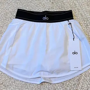 Alo Yoga white tennis skirt with black waistband size L thumbnail 1