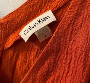 Burnt Orange Calvin Klein Dress v-neck sleeveless fit and flare ruffle thumbnail 2