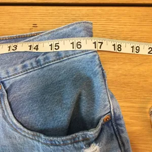 Levi’s 501 Jean shorts 32 button-fly medium wash distressed thumbnail 3