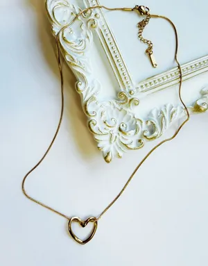 Gold twisted heart necklace minimalist stackable thumbnail 1