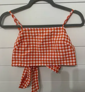 An orange and white gingham crop top with spaghetti straps and a back tie thumbnail 1