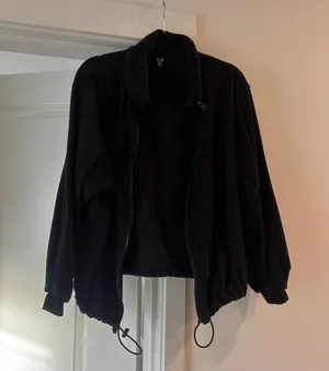 Black fleece zip up jacket with adjustable drawstrings in medium thumbnail 1
