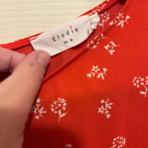 Elodie Red Puff Sleeve Boxy Blouse with small white floral print - size medium thumbnail 2