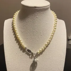 Vivienne Westwood faux pearl and Saturn orb pendant choker, new. thumbnail 1