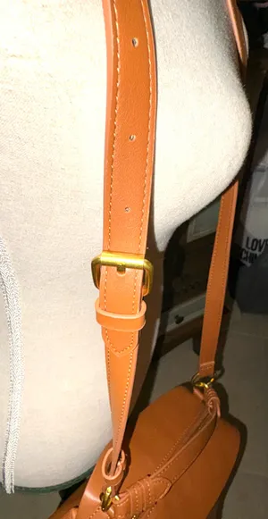 The Free Assembly brown bag features a faux leather structure with top handles and a removable crossbody strap. thumbnail 2