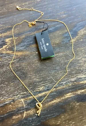 kate spade All Tied Up Pave Bow Gold Tone Pendant Necklace thumbnail 1