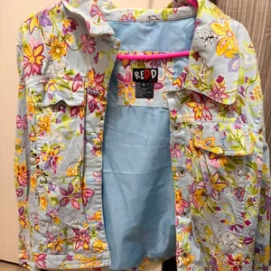 Redd Jeans floral denim trucker jacket featuring colorful flowers and rhinestone buttons thumbnail 1
