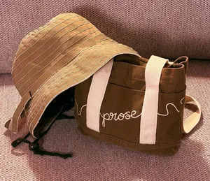 Brown Canvas Tote Bag with White Straps and Brown Bucket Hat thumbnail 1
