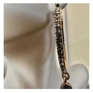 Gold tone hoop earrings with dangling rhinestones thumbnail 7