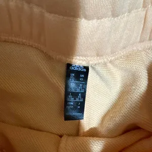 Adidas size xs high‎ waisted peach shorts with white logo thumbnail 3