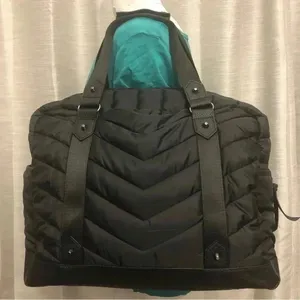Cynthia Rowley Anthropologie’s Quilted Puffer Travel Bag is a stylish and functional accessory designed for travel enthusiasts. Crafted from high-quality materials, this bag features a quilted exterior for added texture and durability. Its spacious interior provides ample room for belongings, while the thoughtful design includes convenient pockets for organization. The soft puffer style adds a chic touch, making it suitable for various occasions, whether heading to the gym or embarking on a weekend getaway. With comfortable straps for easy carrying, this travel bag combines practicality with fashionable flair. thumbnail 1