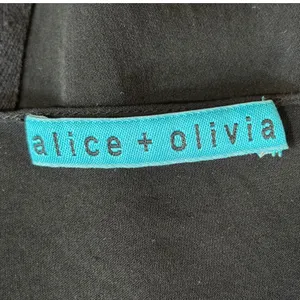 Alice + Olivia Black Silk Blend Short Sleeve Grommet Detail‎ Blouse Est. Small thumbnail 4