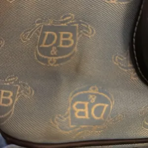 Dooney & Bourke East West Canvas / Leather Trim Donegal Crest Tote Shoulder Bag thumbnail 16