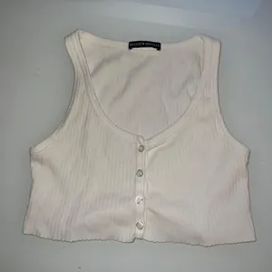 Brandy Melville Extra Cropped White Raw Hem Tank Top thumbnail 1