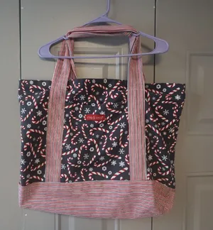 Mia and Tess candy cane and snowflake Christmas tote in black, red and white. thumbnail 1