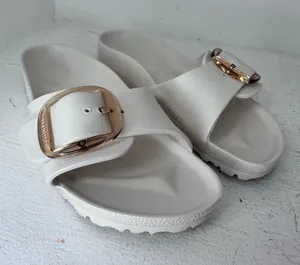 Birkenstock White Slide Sandals with Gold Buckle thumbnail 1