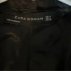 Zara black cropped biker jacket featuring zipper details and side buckle strap thumbnail 3