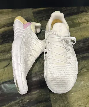Nike Women's White Athletic Sneakers with Subtle Pink and yellow Accent thumbnail 1