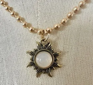 Gold tone sun pendant necklace thumbnail 1