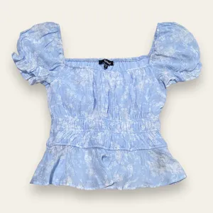NWT Francesca’s Pastel Blue Floral Peplum Top thumbnail 1