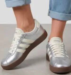 adidas Women’s Silver Metallic Sneakers with White Stripes and Brown Gummy Sole thumbnail 1