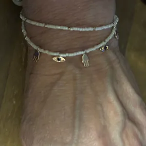 White beaded bolo bracelet with hamsa and evil eye charms thumbnail 1