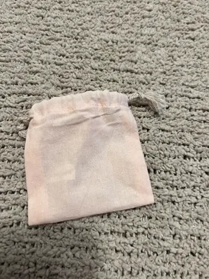 Blush pink velvet drawstring pouch. Gold foil Gorjana logo on front. Soft fabric and secure closure. Perfect for small jewelry or gifts. thumbnail 2