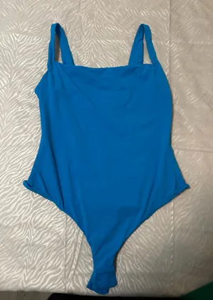 SKIMS Soft Stretch Bodysuit – Blue SKIMS bodysuit in a bright blue shade. Super soft and stretchy with a smooth, flattering fit. Only worn once and stored in a dresser since. No flaws. thumbnail 1