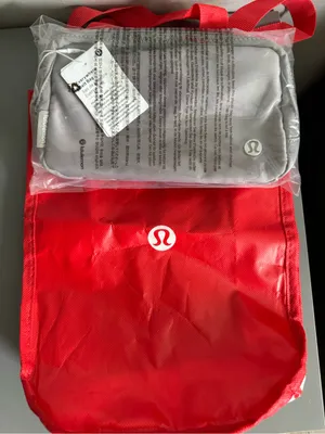 lululemon light grey travel pouch with red packing sleeve thumbnail 1