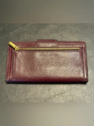 Fossil pebbled leather tab clutch wallet in a deep burgundy or berry color thumbnail 5
