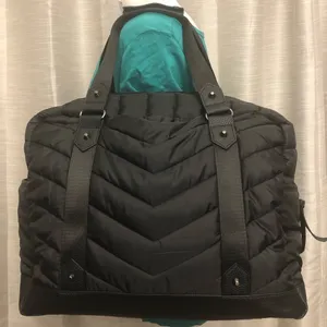 Cynthia Rowley Anthropologie’s Quilted Puffer Travel Bag is a stylish and functional accessory designed for travel enthusiasts. Crafted from high-quality materials, this bag features a quilted exterior for added texture and durability. Its spacious interior provides ample room for belongings, while the thoughtful design includes convenient pockets for organization. The soft puffer style adds a chic touch, making it suitable for various occasions, whether heading to the gym or embarking on a weekend getaway. With comfortable straps for easy carrying, this travel bag combines practicality with fashionable flair. thumbnail 2