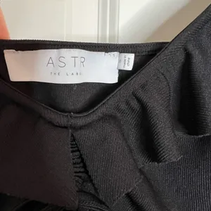 ASTR the Label Black Ribbed Bodysuit with Ruffle Sleeves and Front Cut O… thumbnail 4