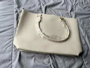 Ulta Beauty Tote Bag – Cream (New in packaging) Add a clean, elegant touch to your outfits with this beautiful tote! It comes in a super versatile cream/ivory shade, featuring a textured faux-leather finish and unique braided handles that give it a chic look. thumbnail 3