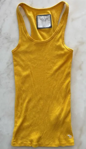 Y2K aesthetic with this classic vintage Abercrombie & Fitch tank top. This piece features a vibrant marigold yellow hue in a flattering, stretchy ribbed knit that's perfect for layering or wearing solo. thumbnail 1