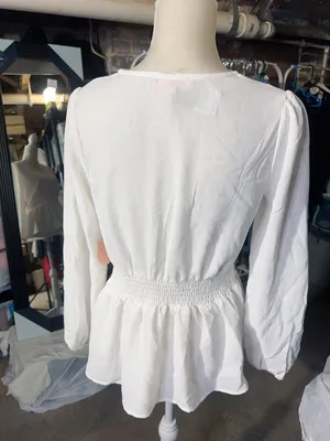 LOS ANGELES white lace V-neck long sleeve shirt top peplum tie cuff New with tag Smoke and pets free Same day shipping Elevate your wardrobe with this stunning white lace blouse from . The V-neckline and long sleeves add a touch of elegance to this top, while the peplum and tie cuff details create a flattering silhouette. The angel character and rose theme make it perfect for any occasion, from casual outings to formal events. Crafted from high-quality lace fabric, this blouse features adjustable features and is available in size S. The solid pattern and delicate lace accents make it a versatile piece that can be paired with any bottom. Whether you're dressing up or down, this Rose & Grey blouse is sure to turn heads. thumbnail 4