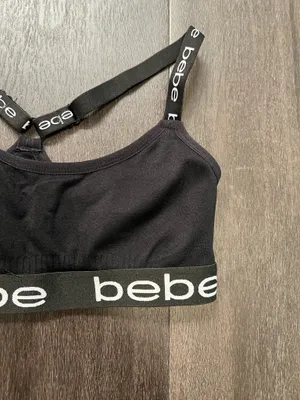 Sleek black bralette featuring bold bebe logo on elastic band. Stretch fabric for light support and comfort. Thin adjustable logo straps with a stylish crisscross back. Clean, minimalist look ideal for layering. Bebe size small thumbnail 2