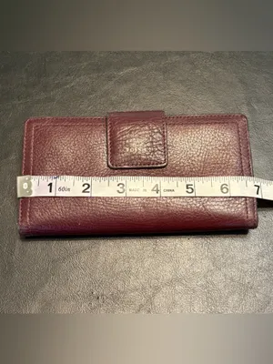 Fossil pebbled leather tab clutch wallet in a deep burgundy or berry color thumbnail 11