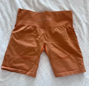 NVGTN High-Waist Rust Orange Bike Shorts thumbnail 1