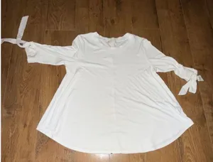 Altar'd State White Ribbed Knit Swing Tunic Top with Bow Tie Sleeves Altar'd State white ribbed knit tunic top in swing silhouette. Round neckline, 3/4 length sleeves with bow tie detail at the cuffs, tunic length hem. Pre-owned with no visible wear. thumbnail 1